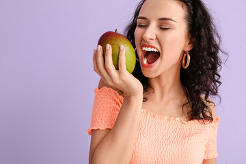 Beautiful woman with fresh mango on color background