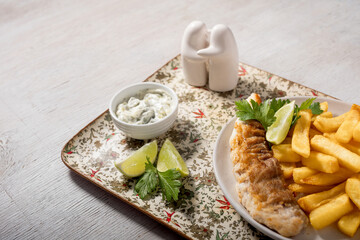 Fish and chips with lemon, parsley and tartar sauce