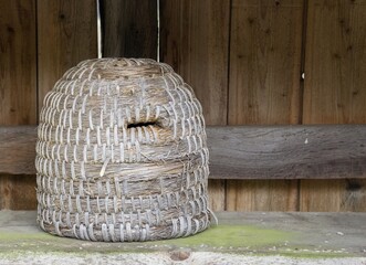 A traditional dome shaped woven bee hive with copy space for your text