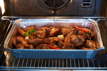 Chicken wings in marinade are baked in the oven.