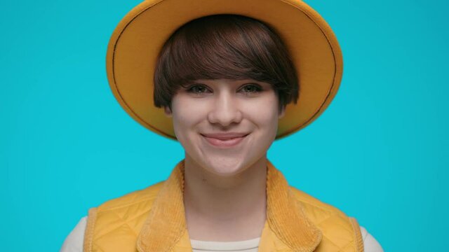 Portrait of charming young woman in trendy yellow hat