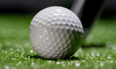 Close up of a used golf ball on a dark background