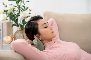 young pretty woman sleeping lying on comfortable couch