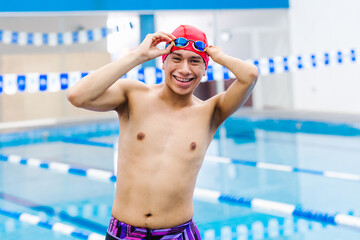 Disabled Swimmer mexican man Training In Pool with hand hypoplasia in disability concept