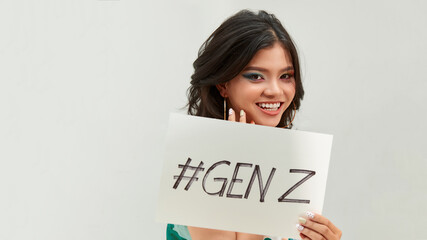 Pretty young excited woman holding #GENZ text in board