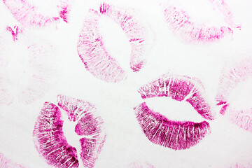 Abstract pink kisses isolated on white background. Lots of female lip prints.