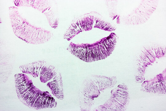 Abstract purple kisses isolated on white background. Lots of lip prints on paper