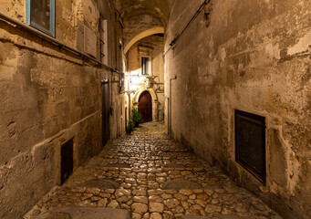 Obraz premium Cobblestone street in the Sassi di Matera a historic district in the city of Matera. Basilicata. Italy