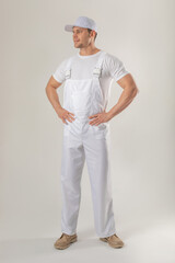 Man worker in white overalls and cap. Mock-up.