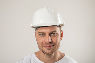 Portrait of a man in a white hard hat. Mock-up. - obrazy, fototapety, plakaty