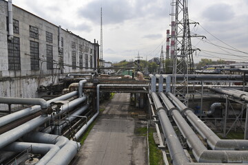 Almaty, Kazakhstan - 10.23.2015 : Metal pipes running along the building, on the territory of the city thermal power plant.