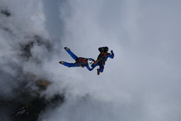 Skydiving. Relative work. Two skydivers are training in the sky.