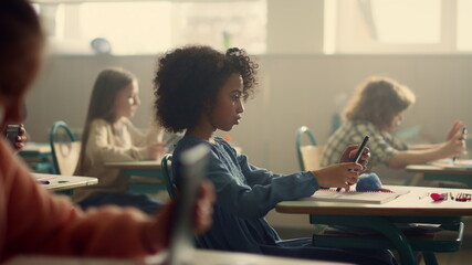 Schoolgirl doing test inline on digital tablet. Girl using tablet computer  © stockbusters