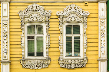 Windows with carved platbands of an old wooden house