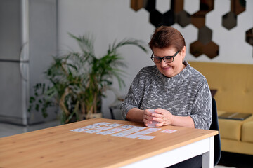 Close up of female holding cards and playing solitaire