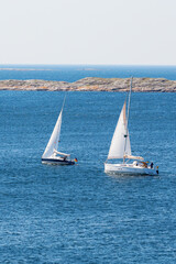 Fototapeta premium Two sailboats sailing on the sea
