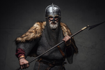 Violent viking fighter dressed in authentic armored clothing