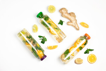 Healthy natural drink with mint leaves, lime, lemon and ginger peace’s flat lay isolated on white background. Food balance and detox concept composition. Part of set.