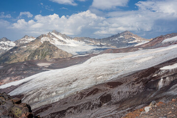 Panoramic view of the Elbrus glaciers. In the foreground we can see the tongue of Maly Azau glacier. Southwest side of Elbrus. Altitude 3500 m. July 2020
