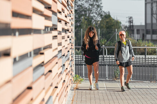 Multi-ethnic women going to the gym for physical exercise. Two girls walking after an outdoor exercise session.