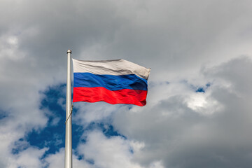 Flag of the Russian Federation on the background of a cloudy sky
