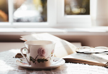 Hot tea with steaming in cinematic tone, Still life cuppa tea with steam on a coffee table with morning light shining from window, Cozy scene of relaxing in afternoon in tearoom