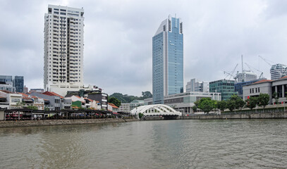  View of Elgin Bridge on the Singapore River. On the bridge pedestrians, on the river ship