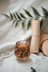 glass of coffee with milk on a white canvas