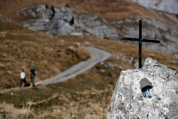 Mountain path. Christian cross on top of a rock.  Sallanches. France.