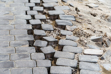 Destroyed paving stones on the footpath. Dismantling and construction of sidewalks in the city. Close-up