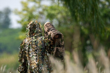Wildlife photographer camouflage in the grassland.