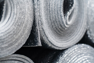 Rolls of polyethylene foam and foil insulation material. Close-up