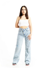 Fototapeta premium Cute beauty young woman in trendy summer street style clothes holding arm behind back. Full body length isolated on white background