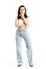 Gorgeous young thoughtful woman in casual street style summer clothes with hand on chin. Full body length isolated on white background