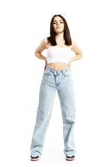 Beautiful summer girl in casual clothes posing with hands on hips with cocky attitude. Full body length isolated on white background