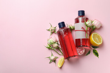 Natural shower gels and ingredients on pink background