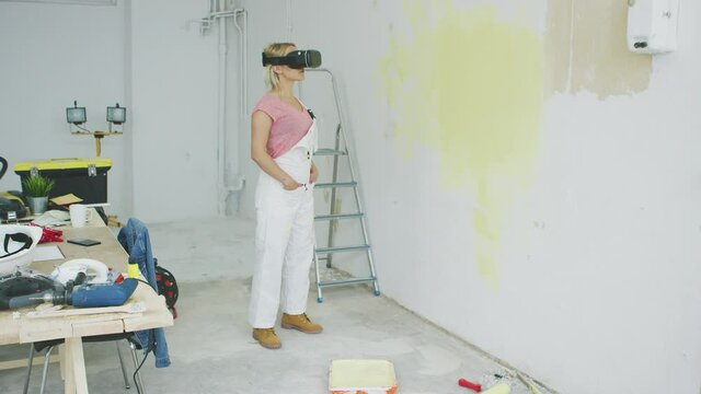 Excited female painter in virtual reality goggles