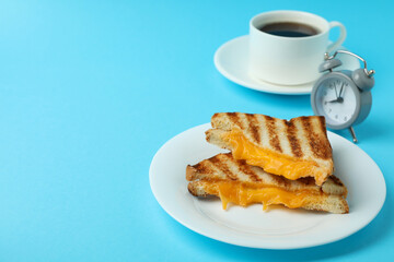 Breakfast concept with grilled sandwiches on blue background