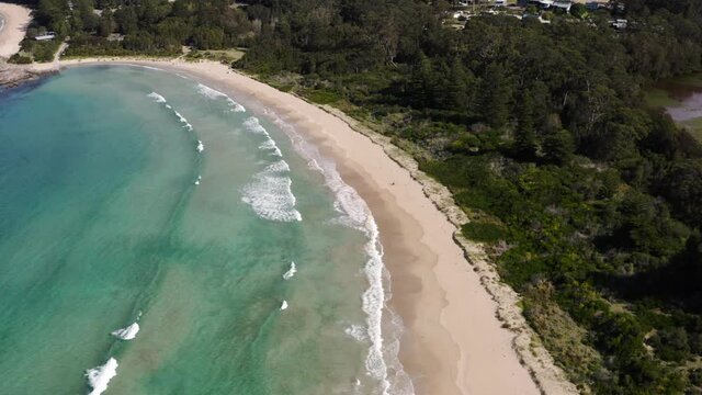 Beach flyby with rolling waves