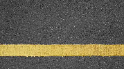 Fototapeta premium Surface rough of asphalt, Grey with yellow line on the road and small rock, Texture Background, Top view