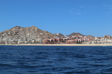Beautiful shot of oceanside resorts with rocky mountains in the background in Los Cabos, Mexico
