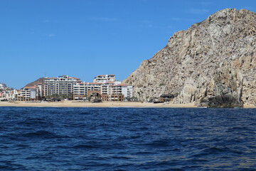 Beautiful shot of oceanside resorts with rocky mountains in the background in Los Cabos, Mexico
