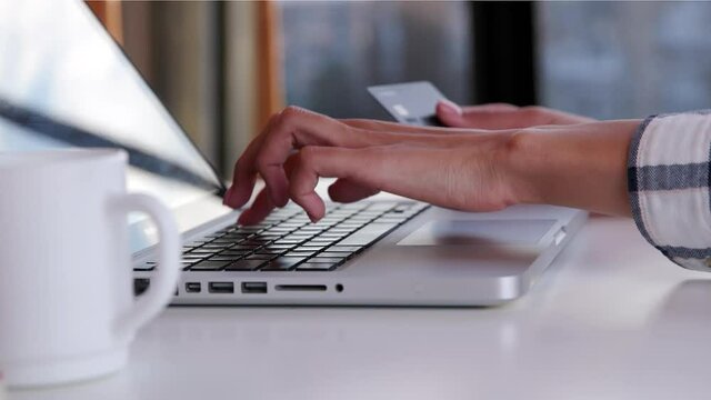 Girl is ready to pay with credit card on an online store