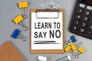 The words Learn to say no written on a white notebook. Work and study concept