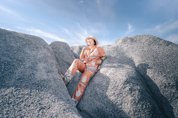 person sitting on a rock