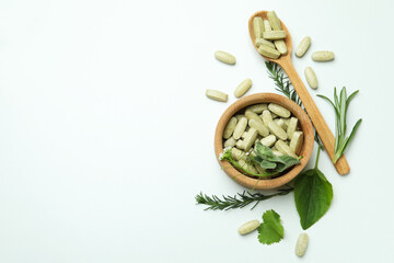 Fototapeta na wymiar Concept of herbal medicine pills on white background, space for text