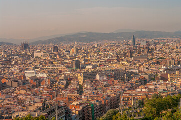Panoramic view over modern and old districts in historical downtown of Barcelona, Spain, cityscape, at summer sunset colors.