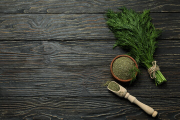 Dill and dry dill on rustic wooden background