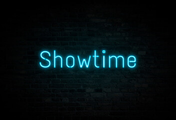 Illuminated and glowing blue Showtime neon sign on dark brick wall.