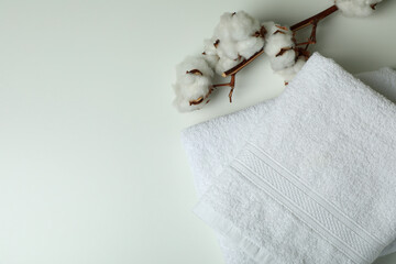 Fototapeta na wymiar Clean folded towels and cotton on white background